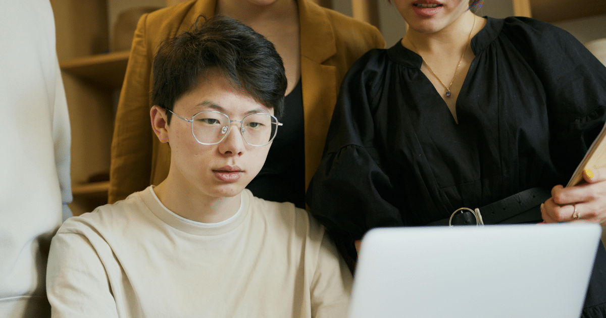 image-2 - California Mental Health Team collaboration for mental wellness techniques. Positive psychology with diverse professionals using laptop, enhancing mental health.