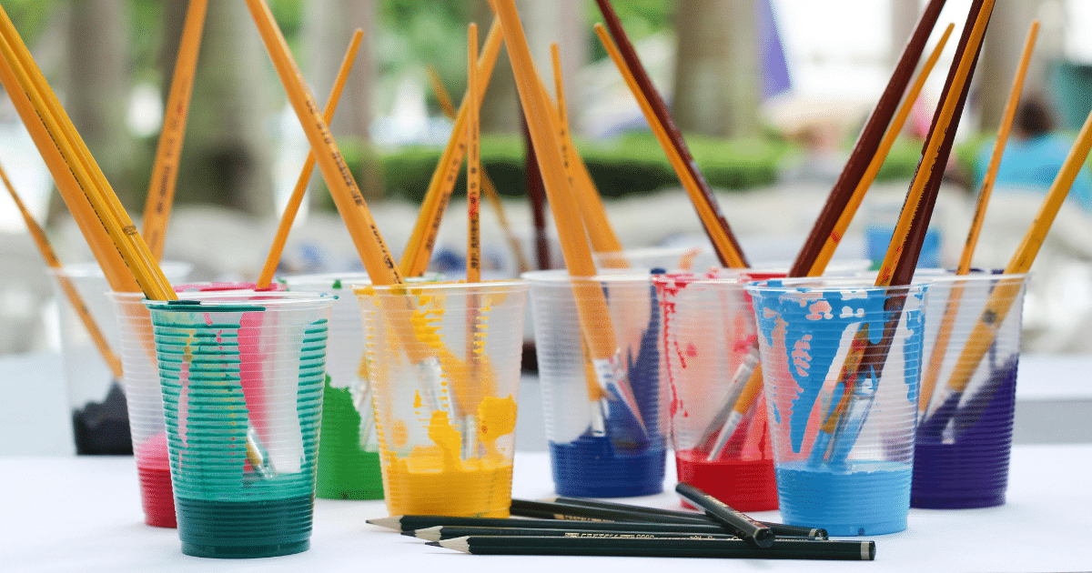 image-22 - California Mental Health Art therapy for grief and loss support: Paintbrushes in cups with colorful paint, pencils, creative coping mechanisms.