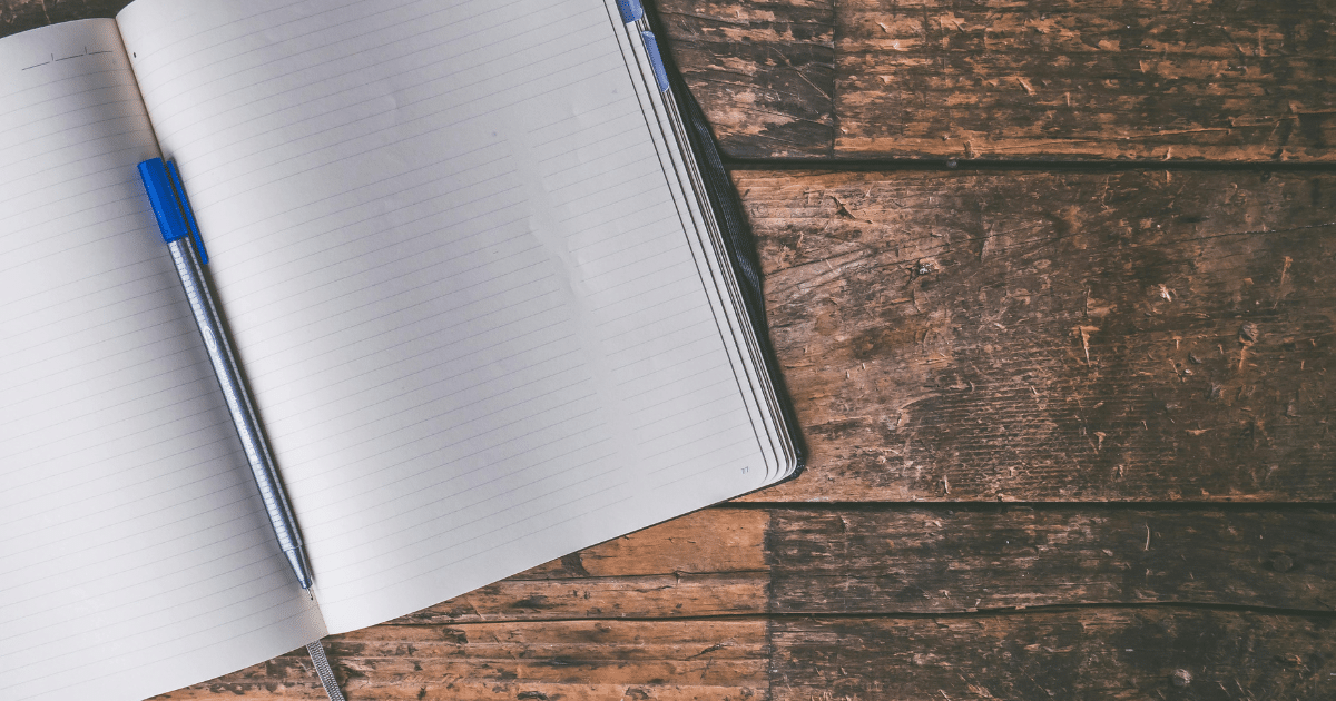 image - California Mental Health Journaling for mental health: Open notebook with a pen on a rustic wooden table, illustrating the benefits of journaling.