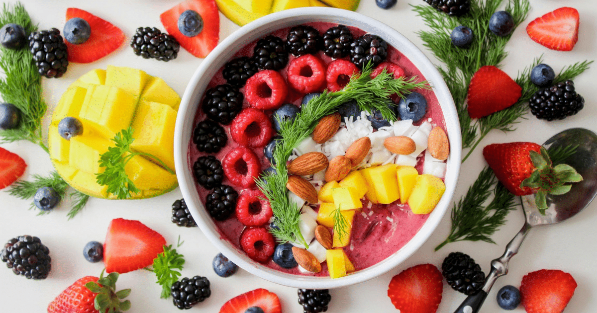 image - California Mental Health Healthy nutrition and mental health concept: Close-up of fruit smoothie bowl with berries, mango, and almonds. Diet affects you.