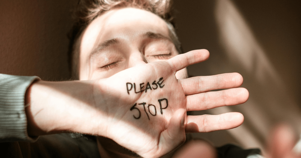 AD_4nXcJd8j6KBv3r-hfQpkpg3vHSBkT1NEzAGA_MwQptAp3bv1mlHFdEflPiwsDl7F0lwMlaCgR3_7RajH9jcAx7NuXOovLQTzH0esdQ4Lm3fTnGLTXlLVNTcIDcqVJuCj0n2s0E6HFKw - California Mental Health PTSD grounding technique: Hand covering face with "Please Stop" written, representing trigger handling and emotional distress.