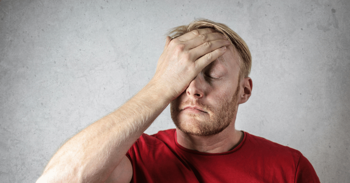 AD_4nXcGD71A-UDseALRcIYBrr2DGQHGsR-z9O1wxiGOSoivCwVAcjdolgAAF-9LQpqy2DWINHx3cEbHQCTYznsi56GySN1brvU-5NXejS6187YSz4ceyfPyEUh3P9abxmZDSeQgx2le5Q - California Mental Health Man with hand on forehead, illustrating psychology goals, stress, or mental health concern. Red shirt, blonde hair.