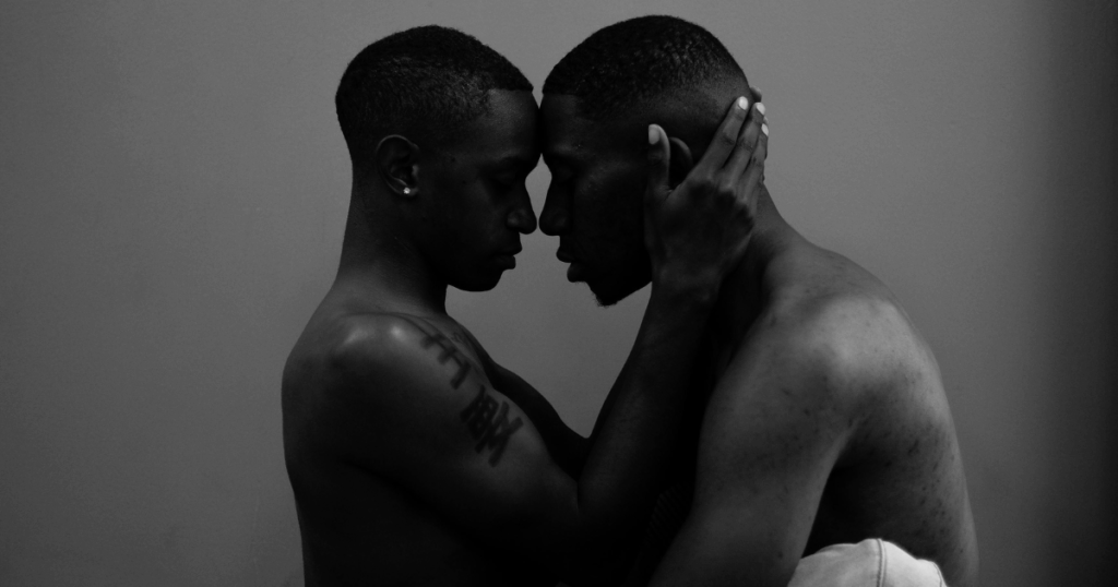 image - California Mental Health Black and white image of two men embracing, touching faces, suggesting intimacy and understanding transvestic disorder.
