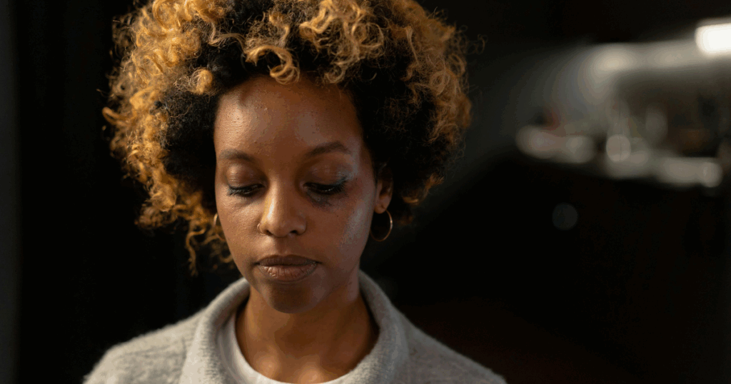 image - California Mental Health Woman with catatonic depression, head down, showing signs of struggle and emotional distress. Mental health awareness.