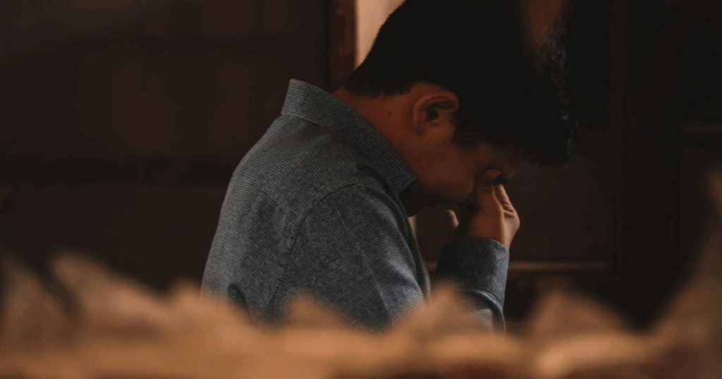 image - California Mental Health Frotteuristic Disorder: Man expressing distress, covering his face with his hand. Mental health, impulse control concept.