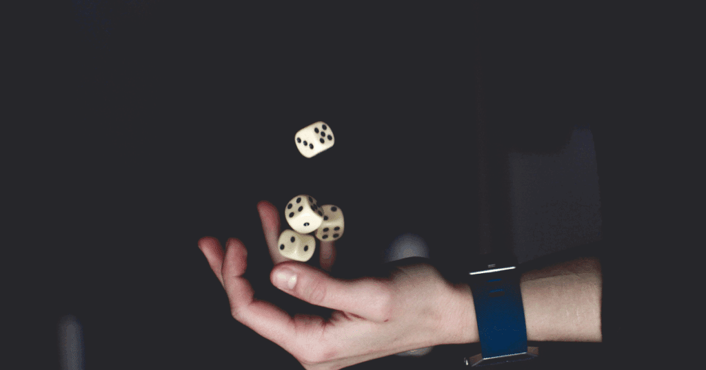 Gambling addiction therapy: Hand tossing dice, representing the risk and uncertainty of gambling. Addiction help concept.
