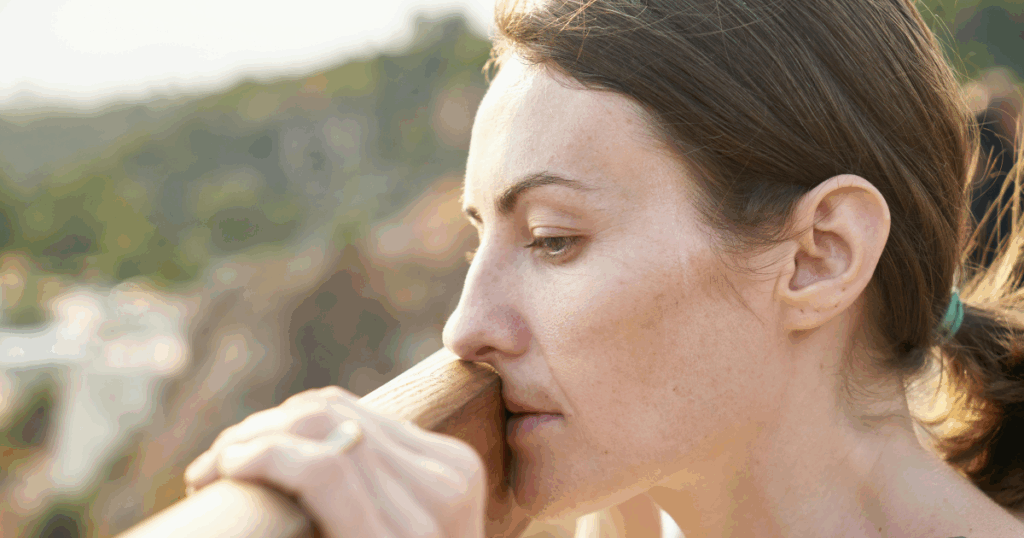Woman thoughtfully overlooking scenery. Mental health and elimination disorders, anxiety, depression awareness concept.